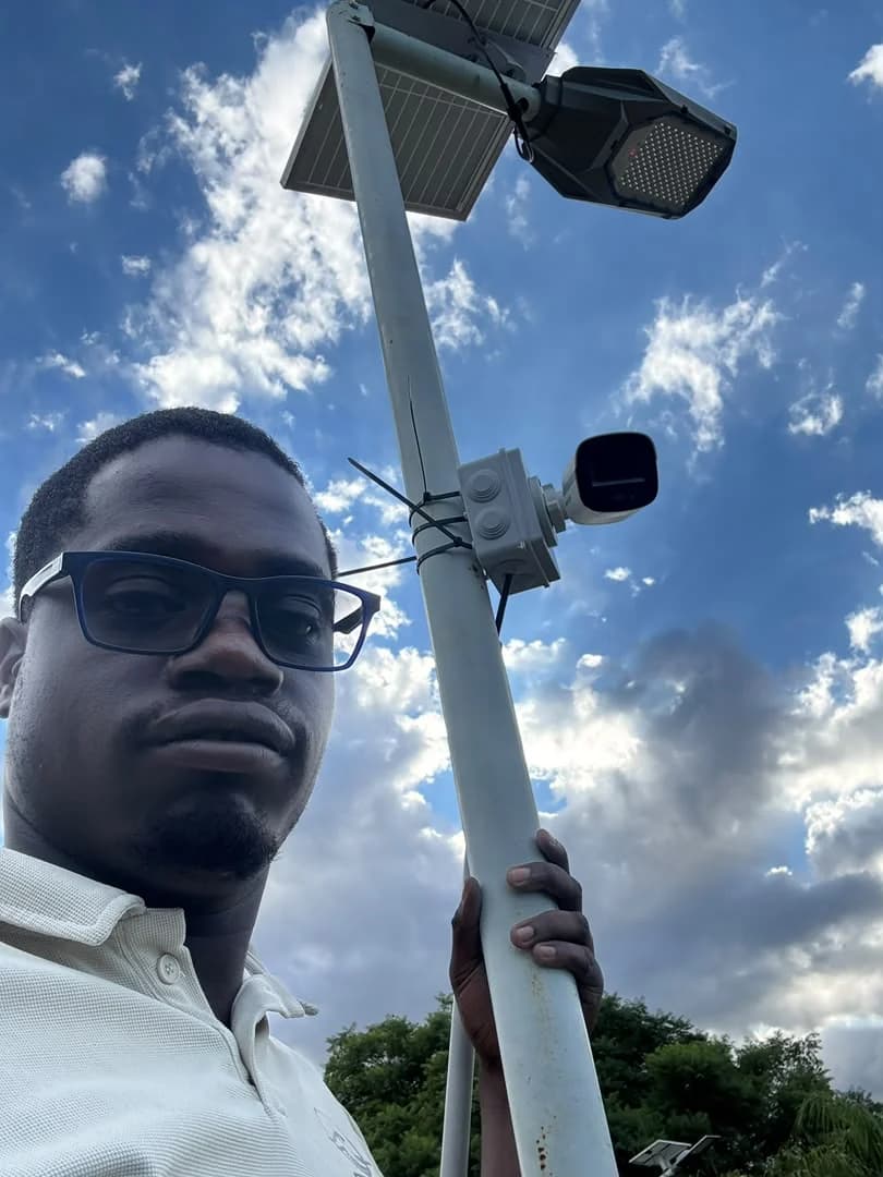 Wikilax Tech outdoor camera installation on a pole beside solar lighting equipment